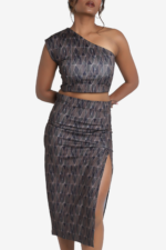 Printed coord set - one shoulder crop top and midi skirt. Set has geometric print on it with multicolor. Top is one shoulder crop top and side zip. Skirt has one side slit. Very comfortable, stylish and easy to wear. Suitable for party.