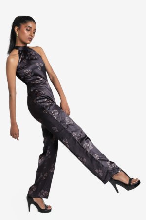 Printed grey jumpsuit, has halter neck and rose prints on it. It is sleeveless, lightweight, flared bottom, suitable for party.