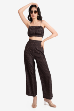 Brown co-ord set with a crop top and flared pant has geometric print on it. crop top has gathers on waist, noodle straps and side concealed zipper. Pant had side concealed zip, comfortable and relaxed fit. Suitable for women who prefer fashionable, trendy outfits and are looking for party wear.