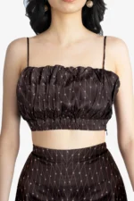 Brown co-ord set with a crop top and flared pant has geometric print on it. crop top has gathers on waist, noodle straps and side concealed zipper. Pant had side concealed zip, comfortable and relaxed fit. Suitable for women who prefer fashionable, trendy outfits and are looking for party wear.