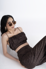 Brown co-ord set with a crop top and flared pant has geometric print on it. crop top has gathers on waist, noodle straps and side concealed zipper. Pant had side concealed zip, comfortable and relaxed fit. Suitable for women who prefer fashionable, trendy outfits and are looking for party wear.